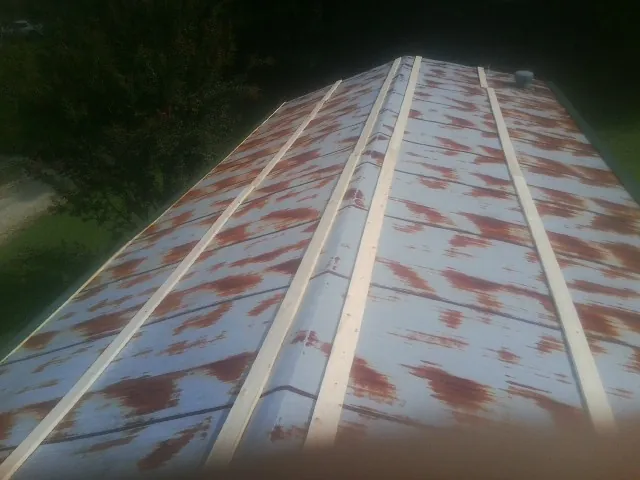 Rusted metal roof panels with new wood purlins before replacement — Storm Damage Roof Repair in Stonyford by Roofing Brothers